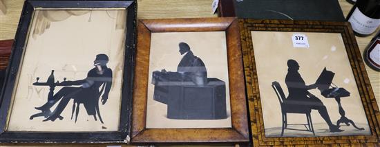 Auguste Edouart, cut paper and watercolour silhouette of a gentleman seated at a table, signed and dated 1834,